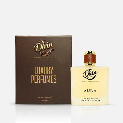 A 100ml bottle of Divin Scent Aura Eau De Parfum featuring a frosted glass design with a golden cap wrapped in brown leather and elegant black typography.